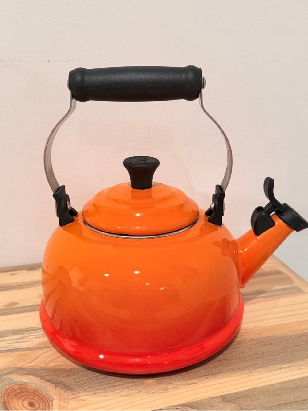 LE CREUSET Orange Flame Enamel Whistling Kettle with Black Handle